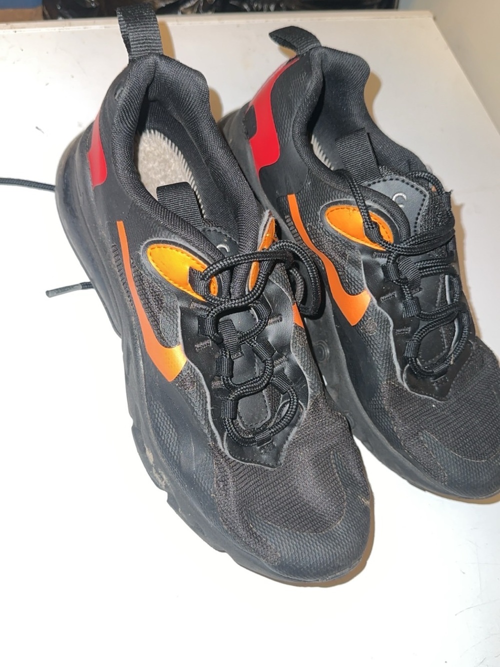 Nike Kids Black Sneakers with Orange and Red Accents
